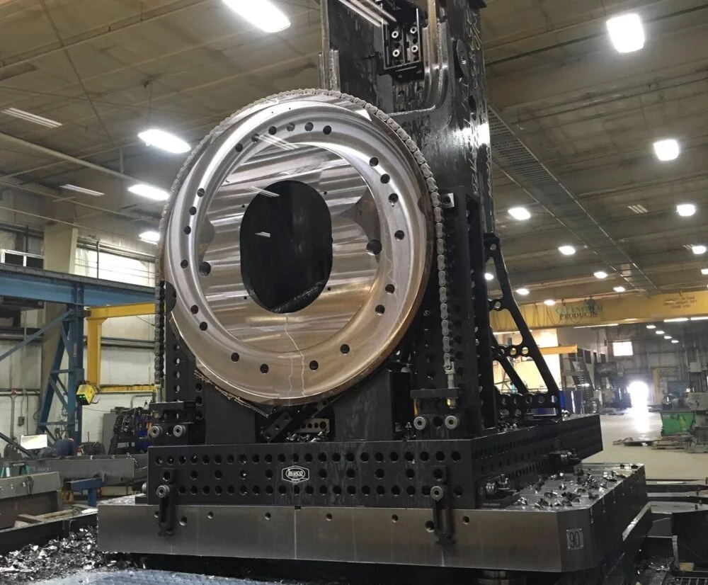 Large Turntable for mobile crane. Machining fixture built from D28 and Bluco machining components. Machine is a large HMC.